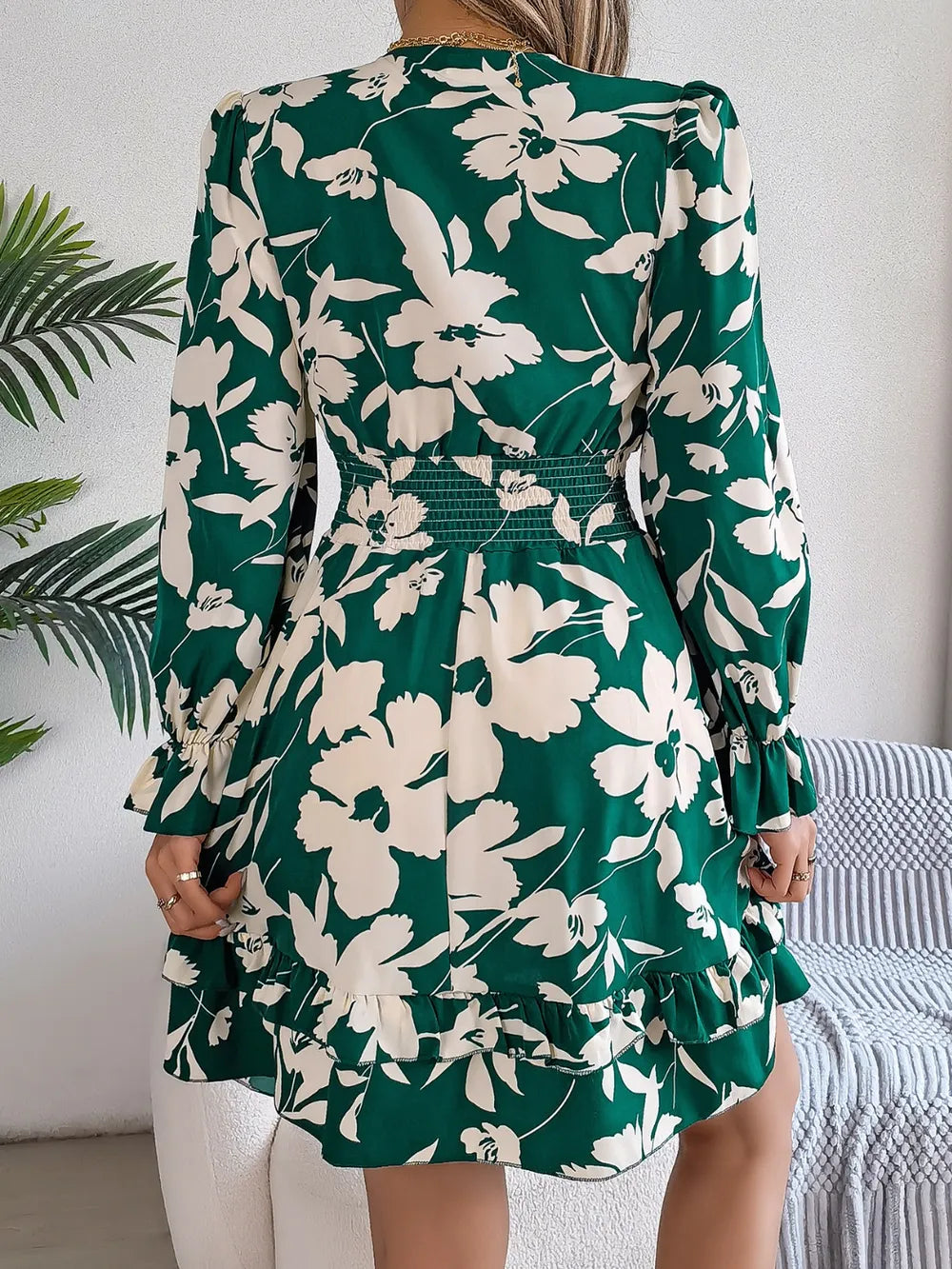 Dark green floral long-sleeve dress with tied V-neck and layered ruffle hem