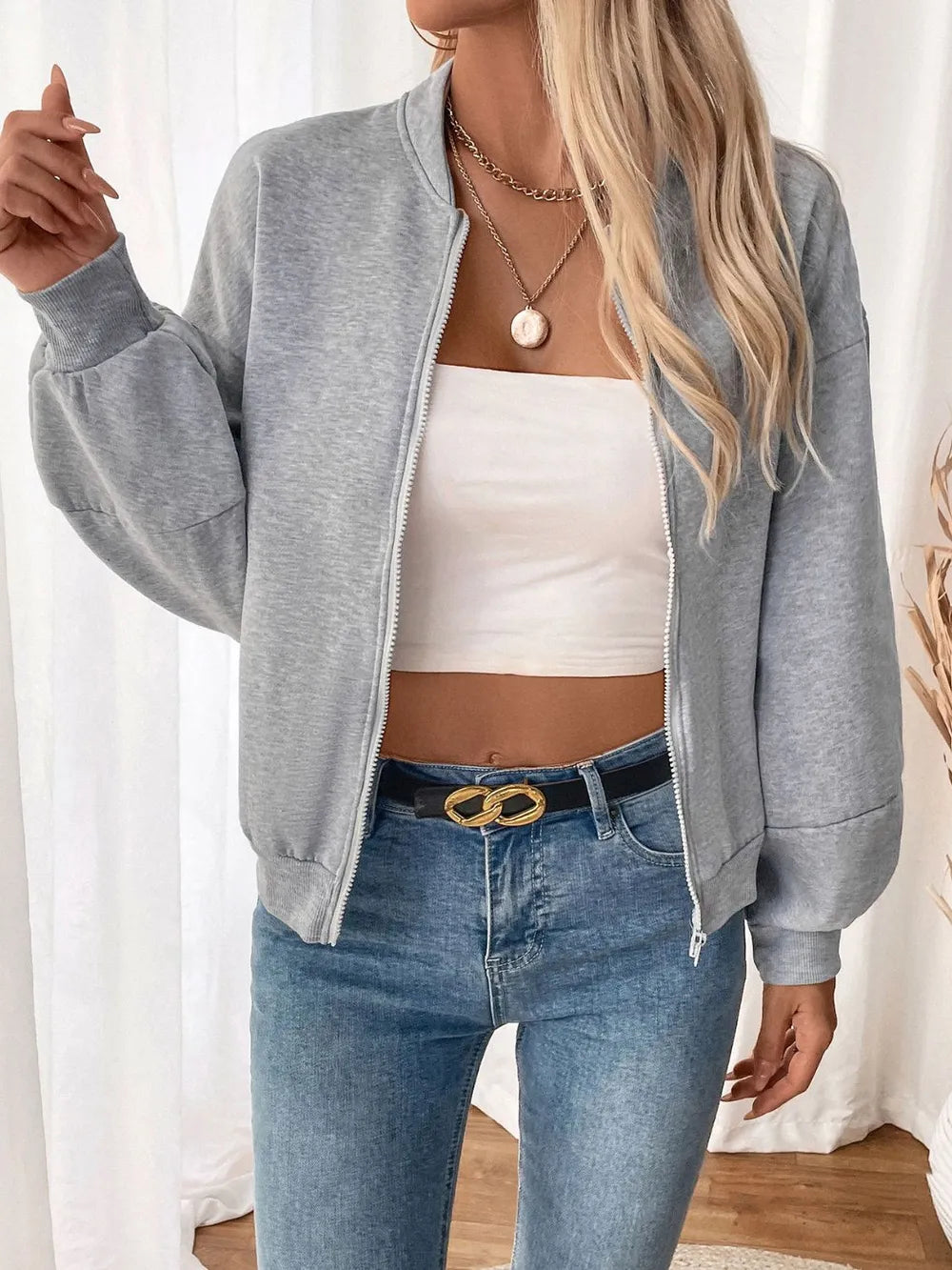 Light gray zip-up long sleeve sweatshirt, front zip partially open