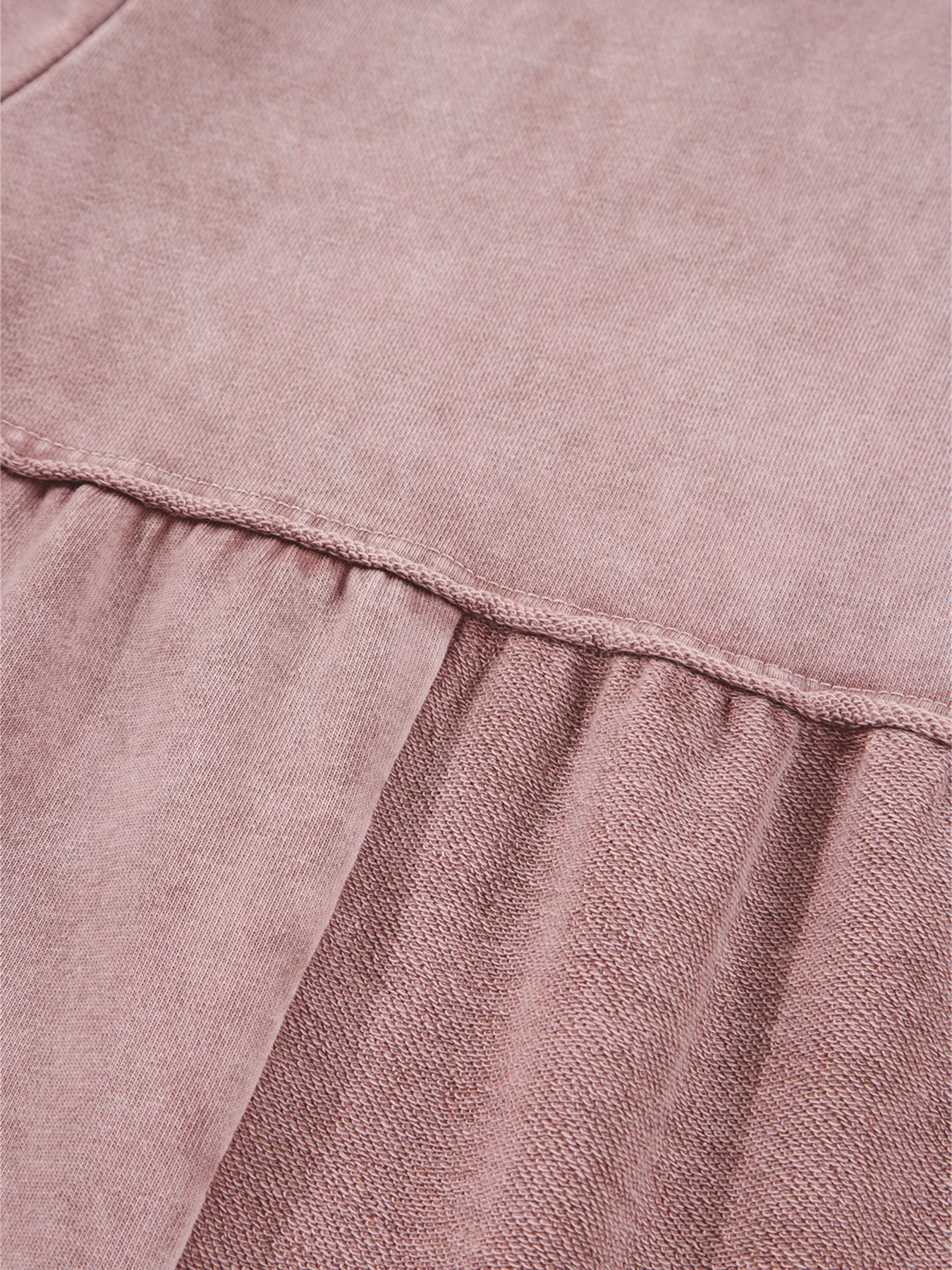 Dusty pink tiered wide-leg pants with ruffled tier seam and textured fabric