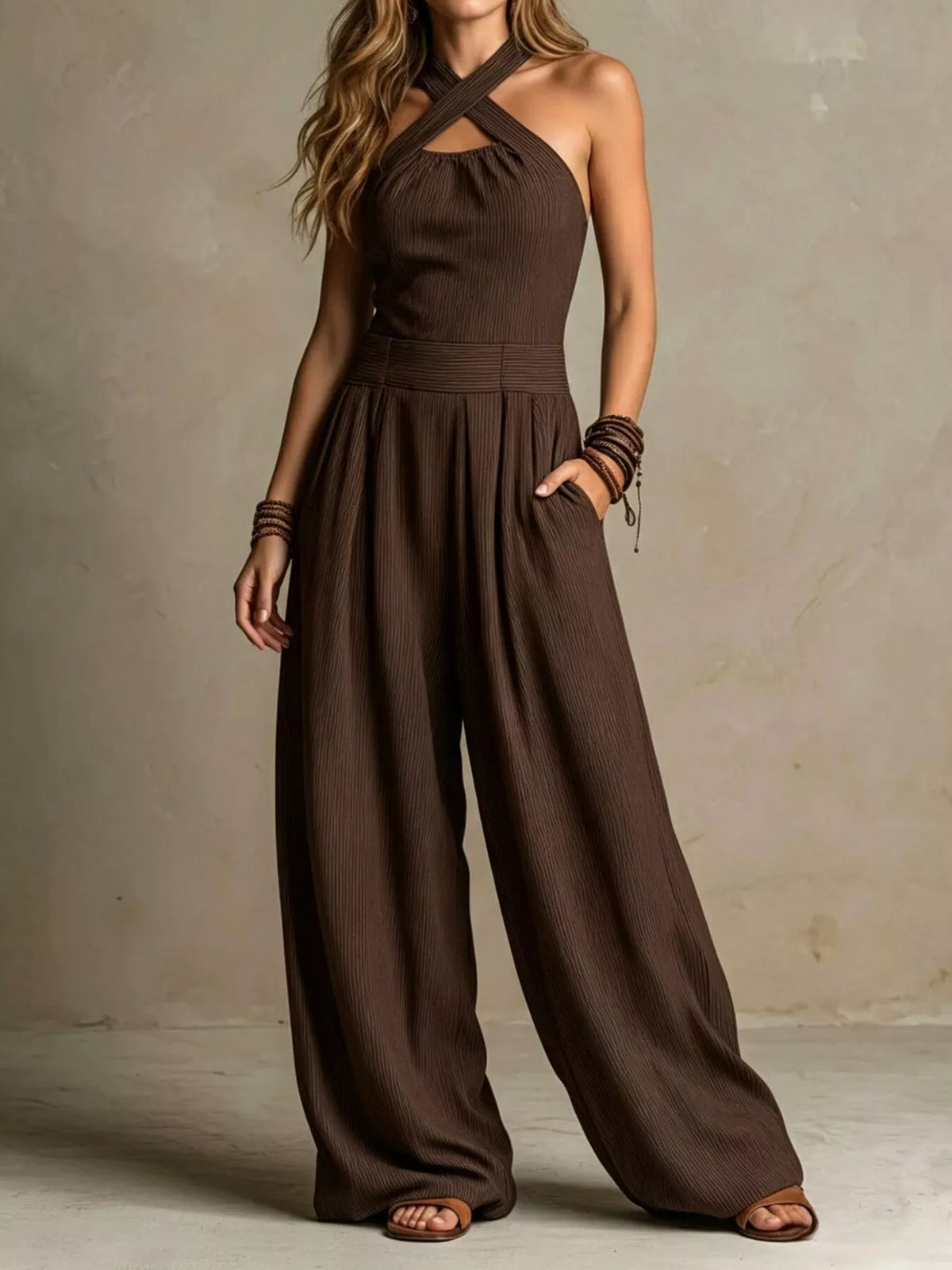 Dark brown halter crisscross wide-leg jumpsuit with gathered waist and flowy pants