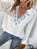 Long-sleeve blouse in white with blue paisley embroidery and V-notch neckline