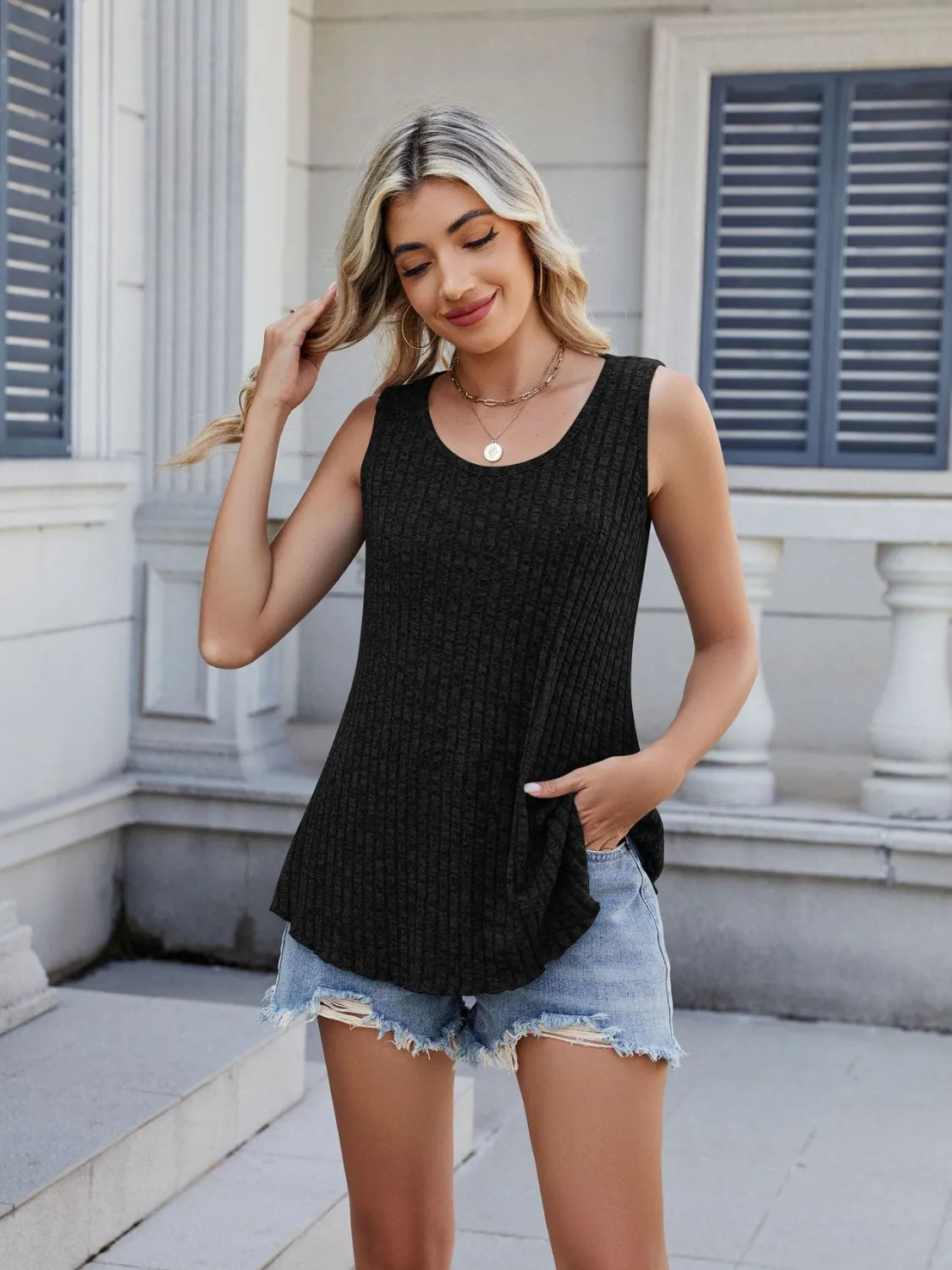 Black ribbed round-neck tank with sleeveless cut and curved hem