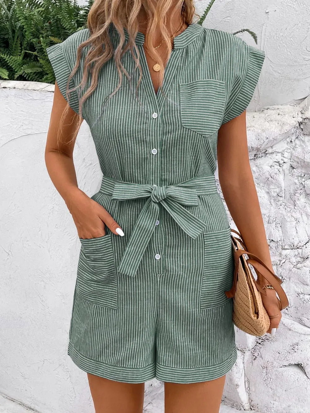 Green striped romper with notched V-neck, waist tie, button front, patch pockets, short sleeves