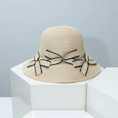 Bowknot straw sun hat with black-and-beige bow applique on light straw brim