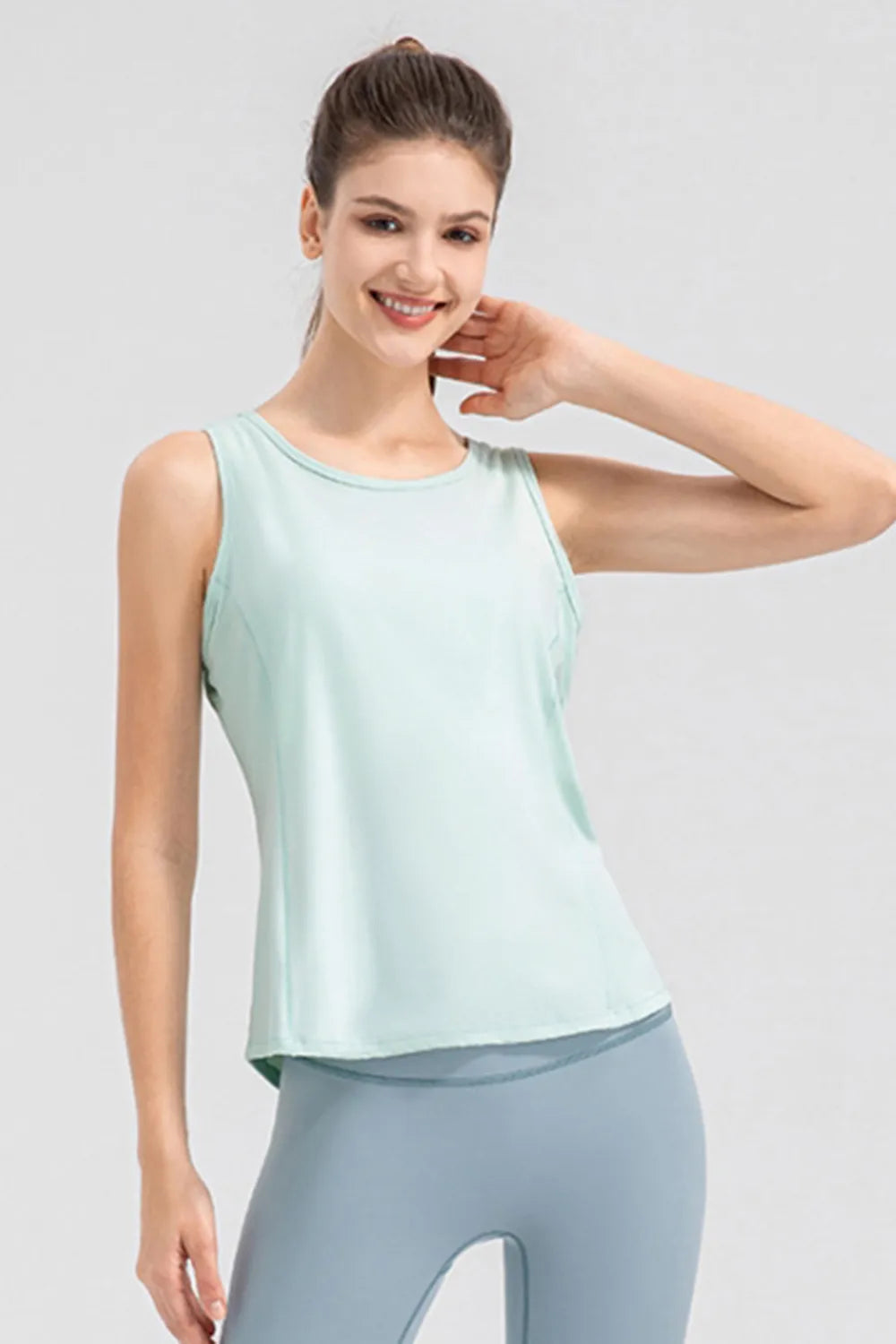 Women’s aqua active tank top with wide straps and round neckline, side view