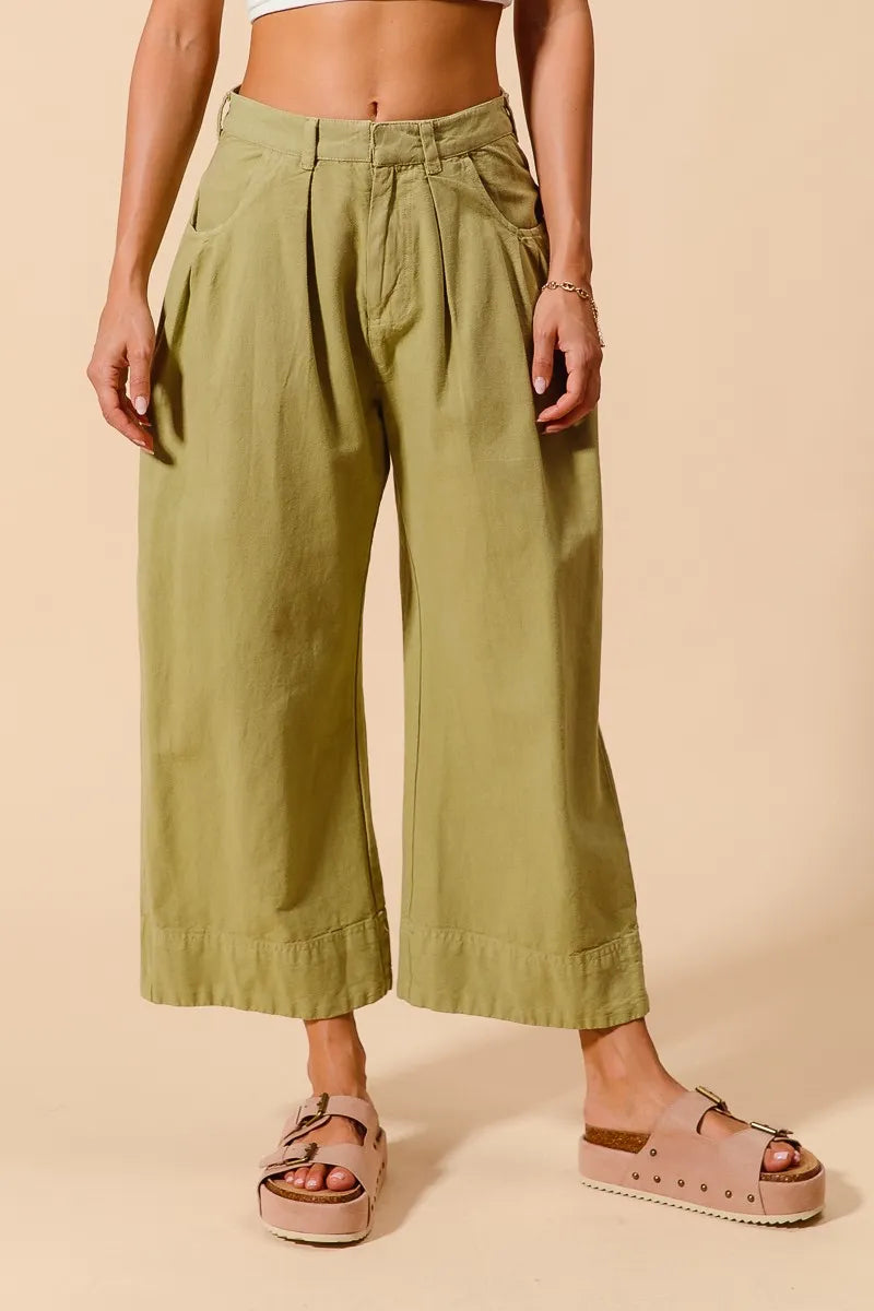 Sage green wide-leg chino pants with side pockets, relaxed mid-rise fit