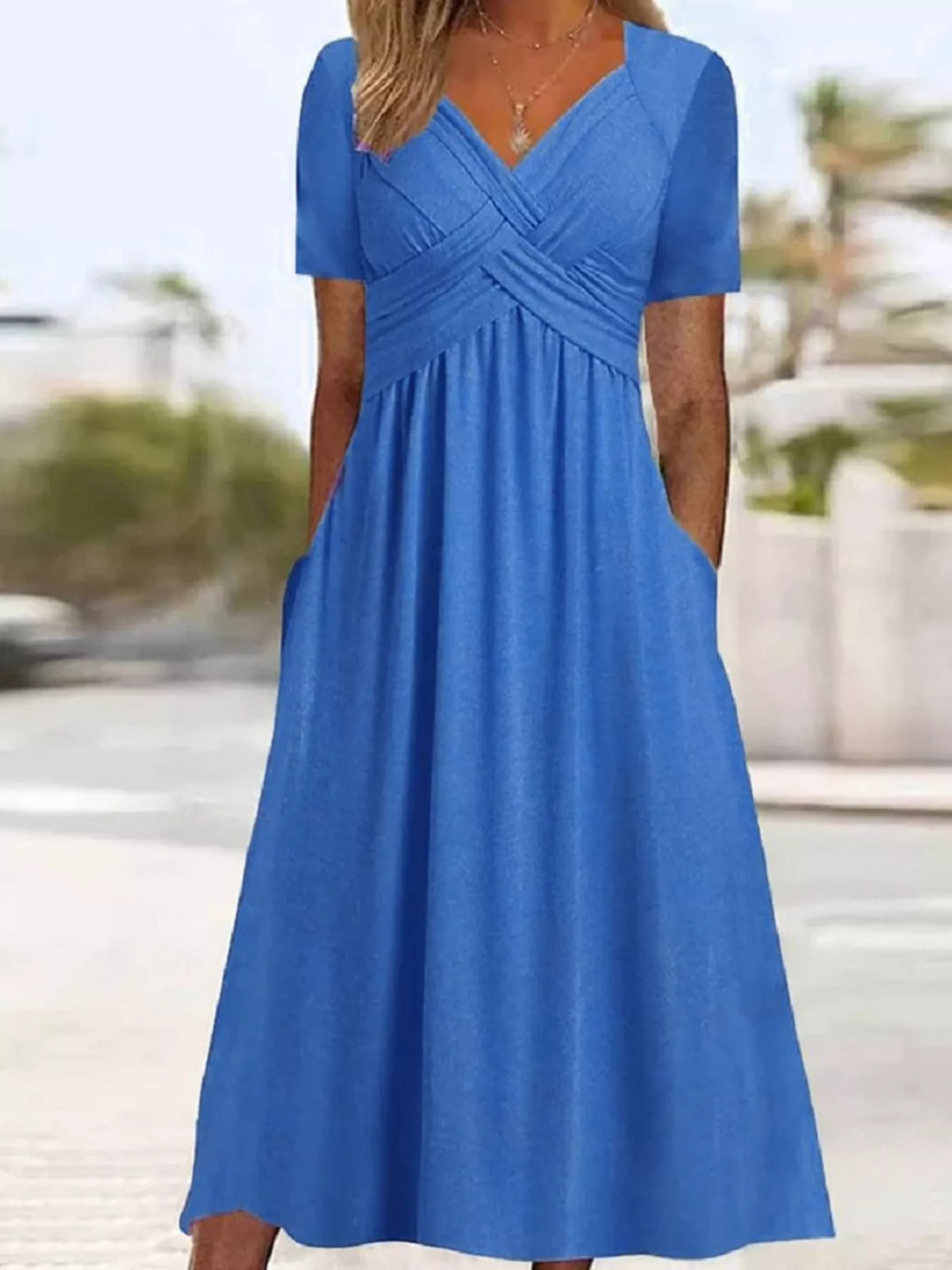 Blue high-waist midi dress with crisscross V-neck and short sleeves
