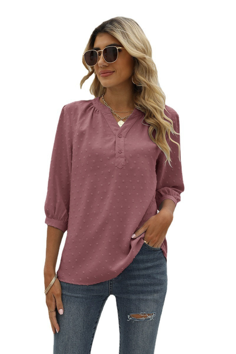 Blush pink swiss dot notched-neck blouse with 3/4 sleeves and button placket