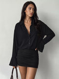 Black blouse-style mini dress with button front, ruched skirt, and flared sleeves