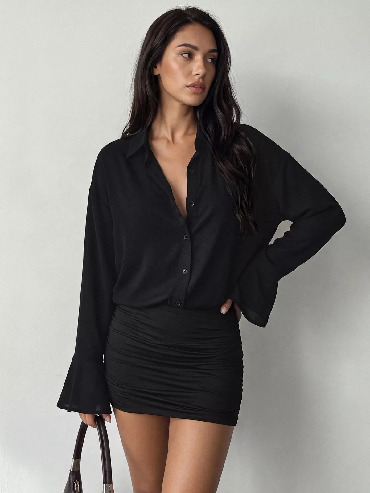 Black blouse-style mini dress with button front, ruched skirt, and flared sleeves