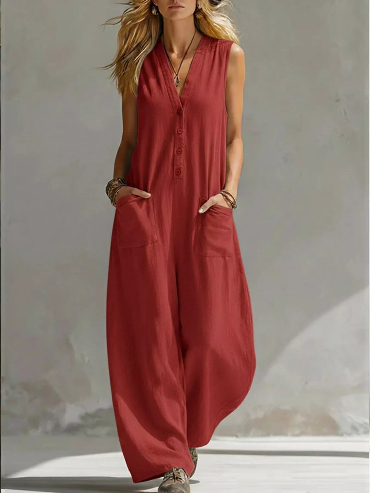 Red V-neck sleeveless wide-leg jumpsuit with button front and side pockets