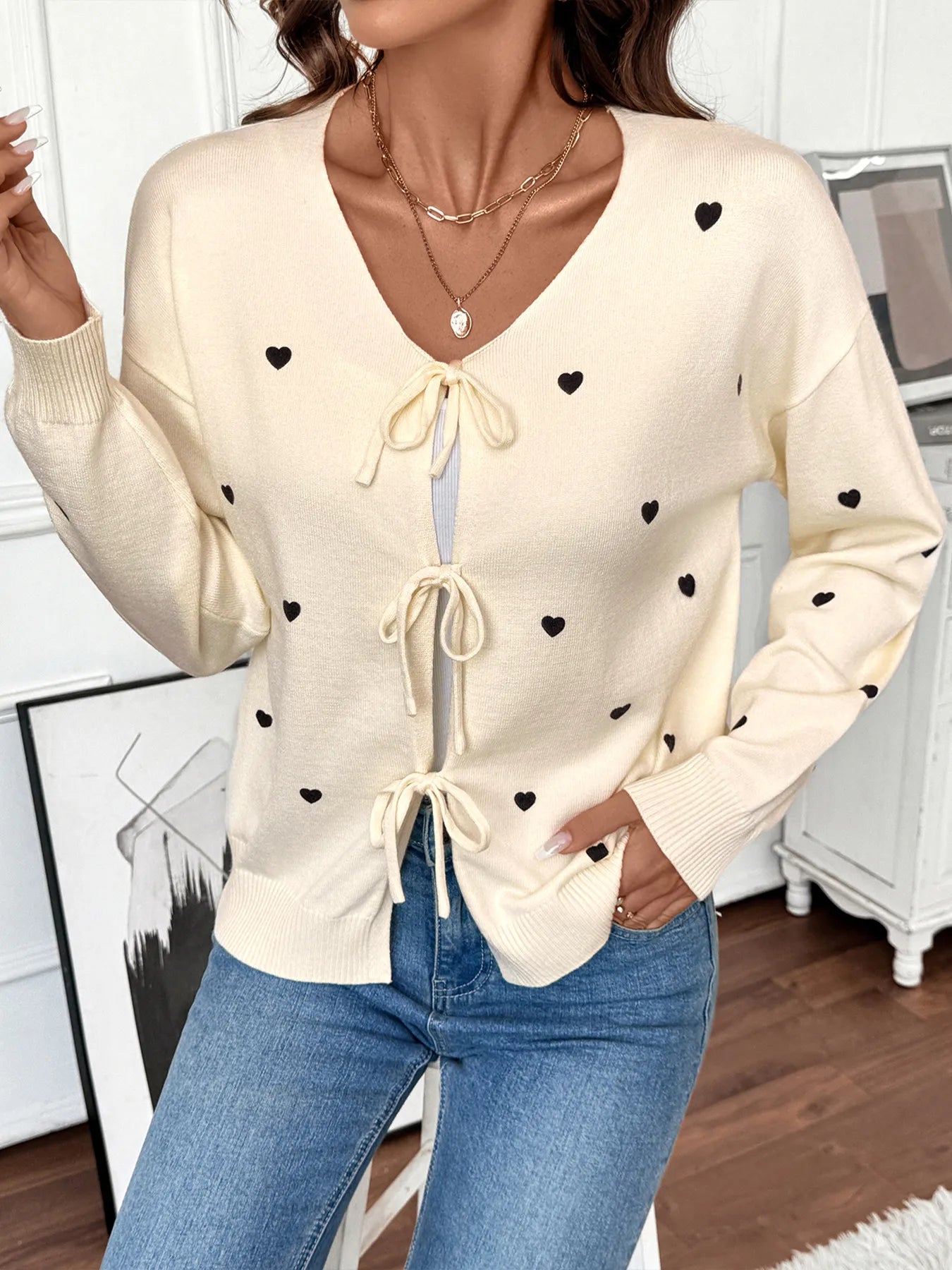 Cream heart tie-front long sleeve cardigan with front bow ties and ribbed sleeve cuffs
