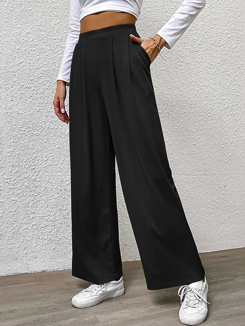 High-waist straight black pants with front pleats and wide-leg fit