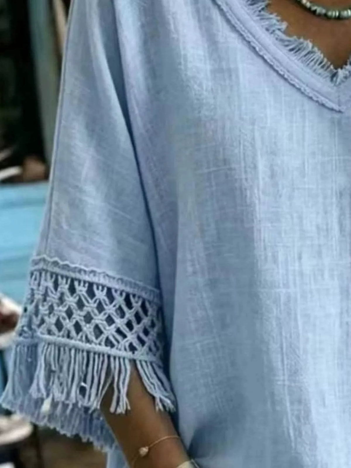 Women’s blue V-neck loose blouse with fringe trim and lace sleeve detail