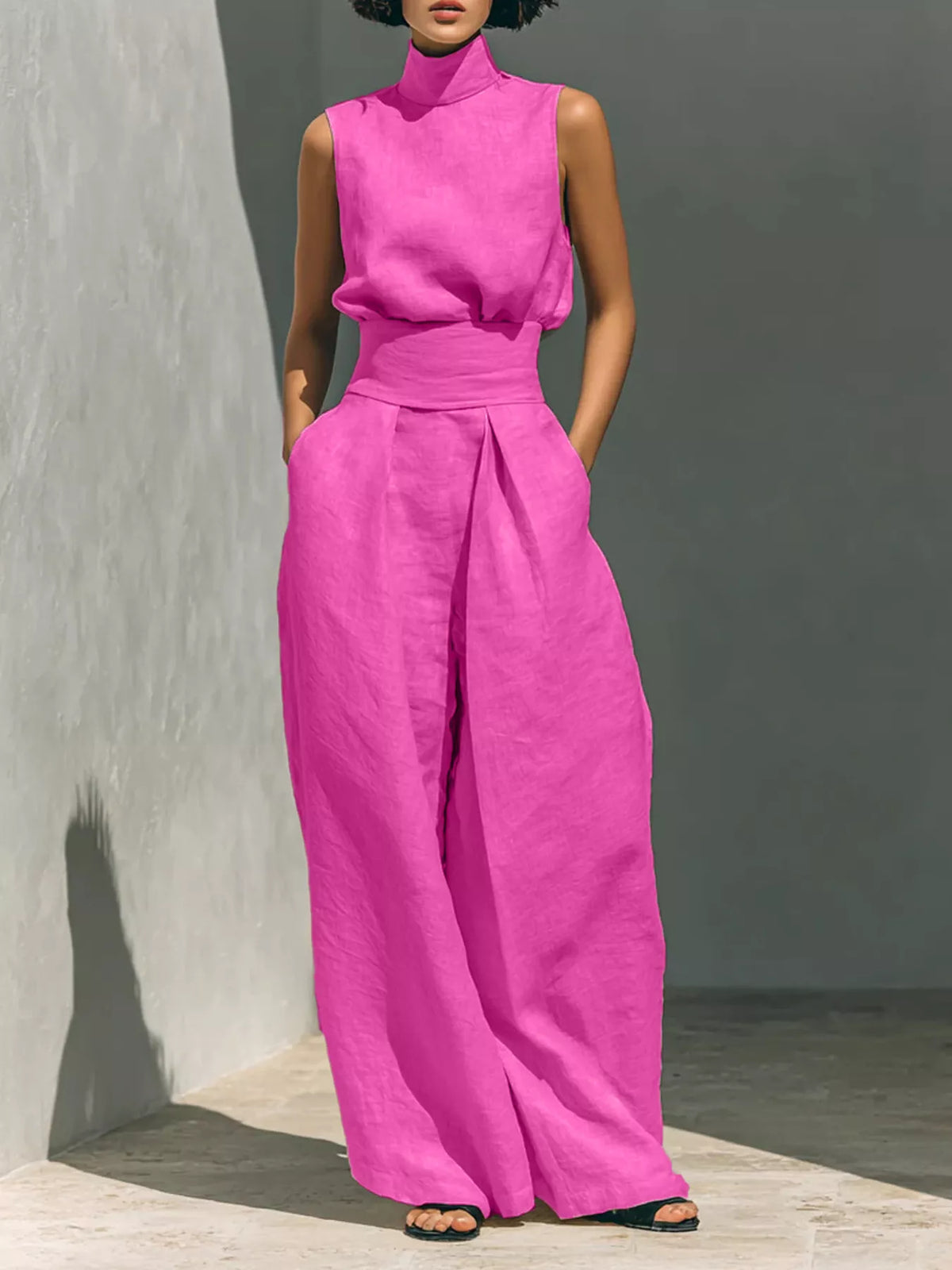 Sleeveless wide-leg jumpsuit in bright pink with smocked waist and high neckline
