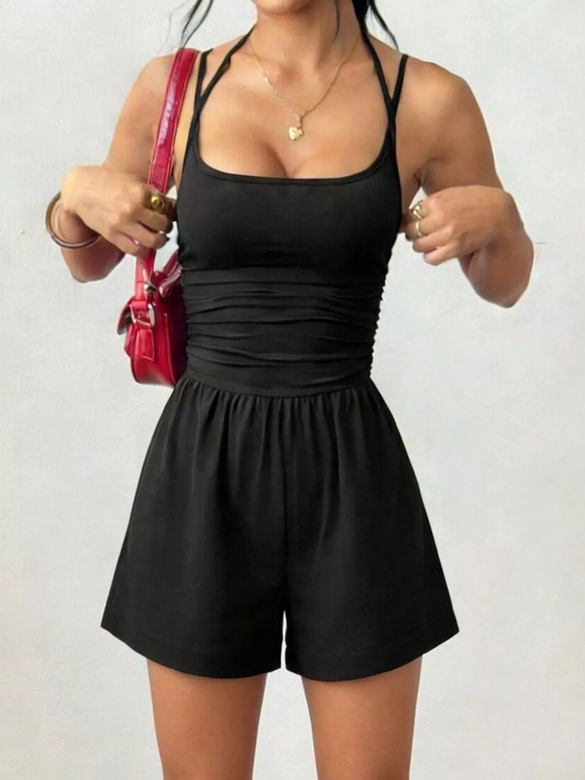 Black sleeveless ruched spaghetti strap romper with wide-leg shorts and elastic waist