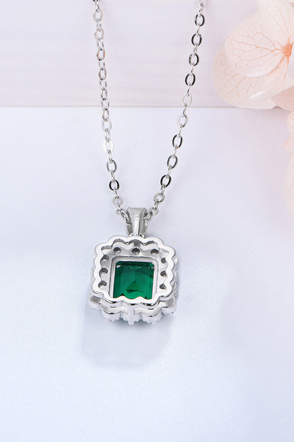 Square green emerald pendant on 925 sterling silver chain with scalloped frame and halo stones