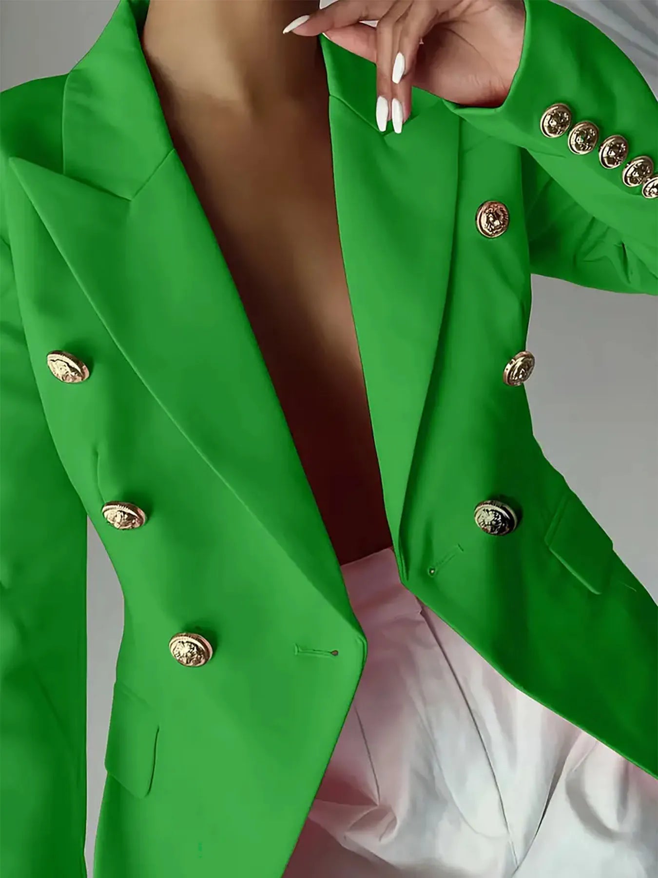 Green lapel blazer front with gold-tone decorative buttons and buttoned cuffs