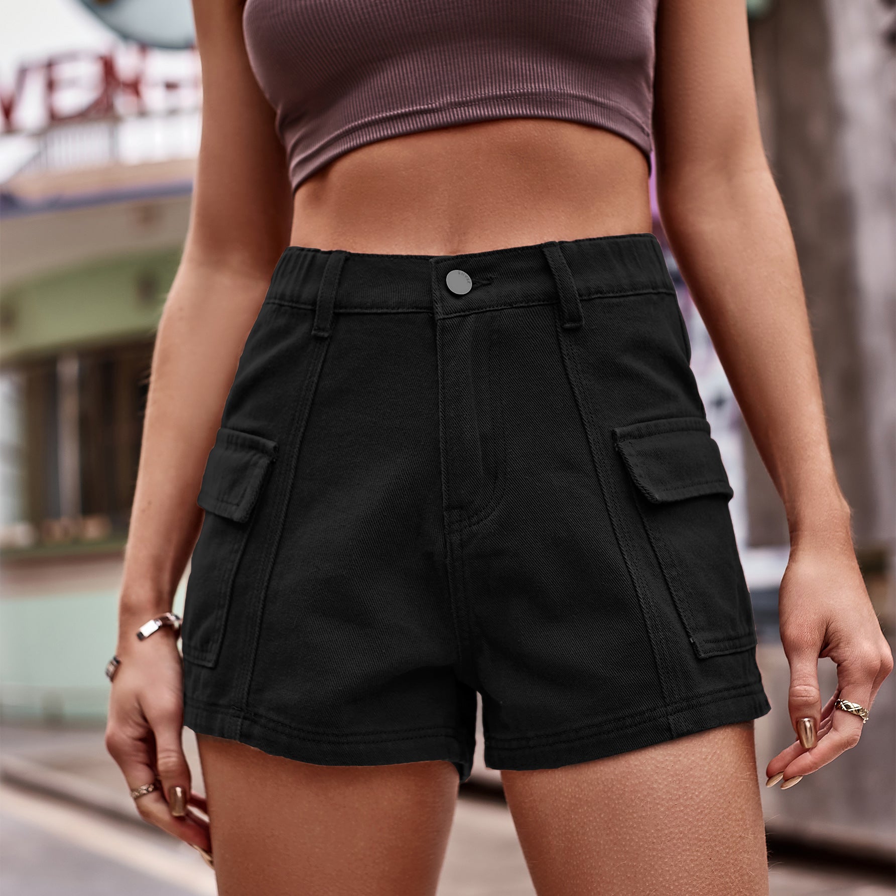 Black high-waist denim shorts with button fly and cargo patch pockets
