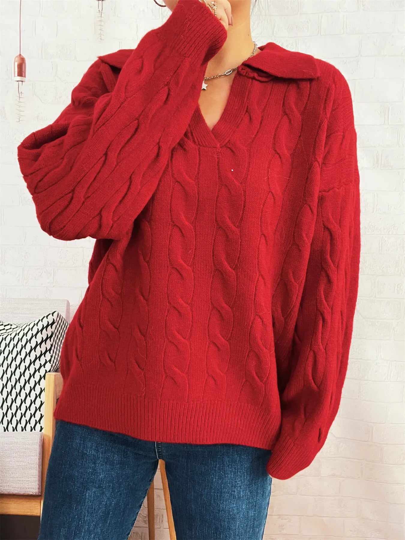 Red cable knit Johnny-collar sweater with cable texture, long sleeves, ribbed cuffs