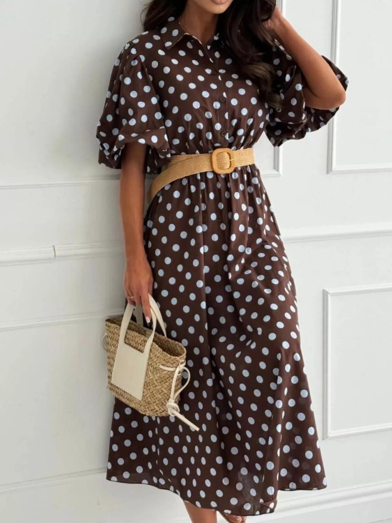 Dark brown polka-dot puff-sleeve midi dress with button front and tan waist belt.