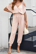 Pink surplice cold-shoulder frill jumpsuit with gathered waist and jogger cuffs