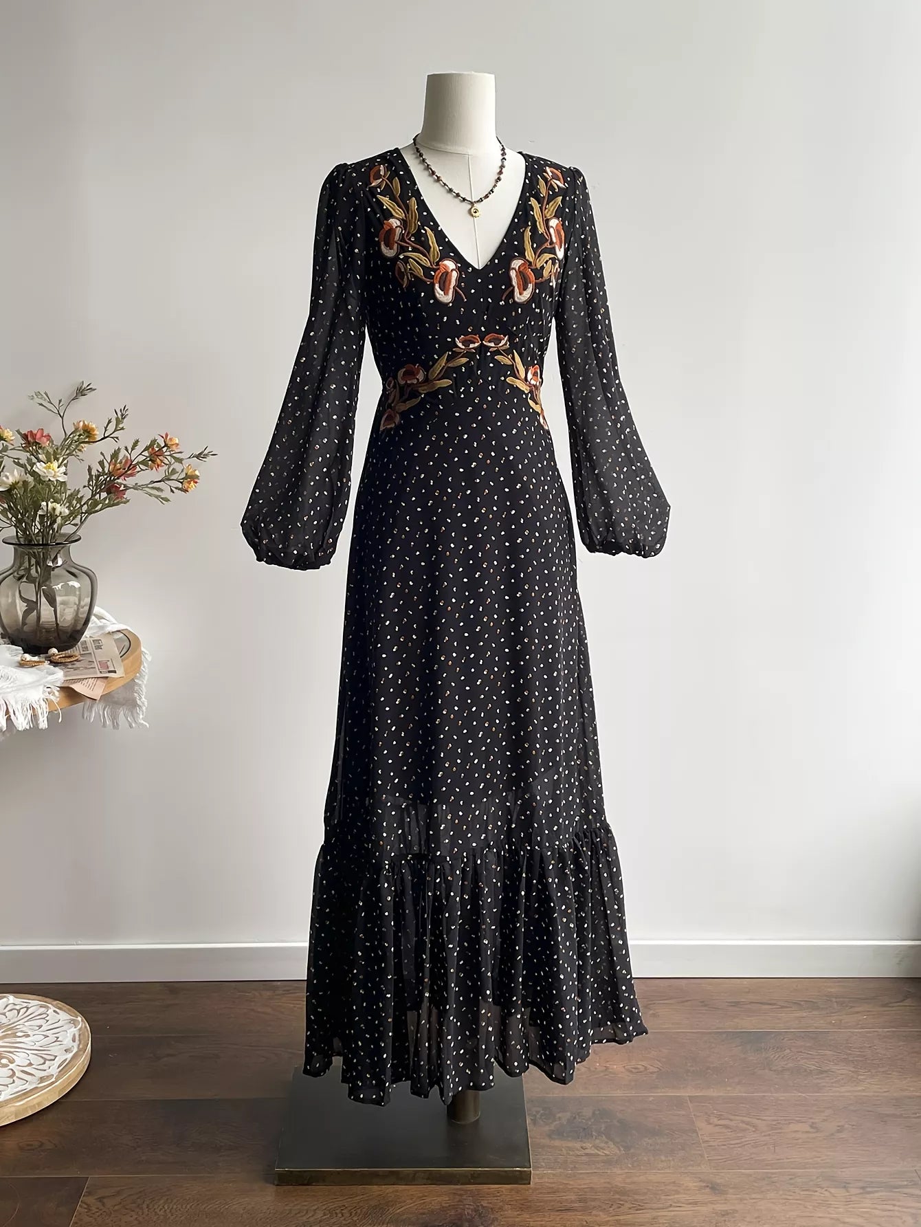 Black long-sleeve polka dot maxi dress with V-neck and floral embroidery detail