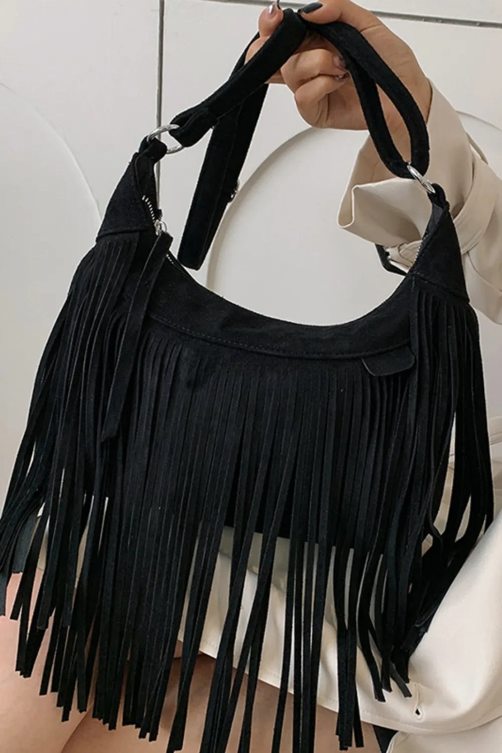 Black suede fringe shoulder bag with wide shoulder strap