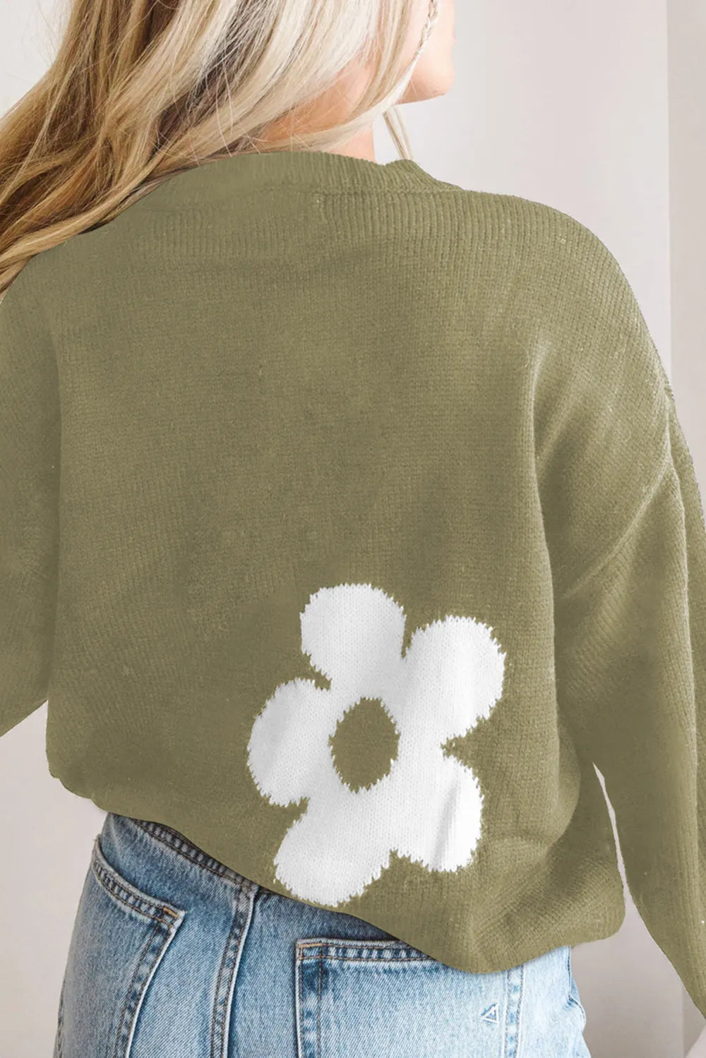 Olive green long-sleeve sweater with white flower motif on the back