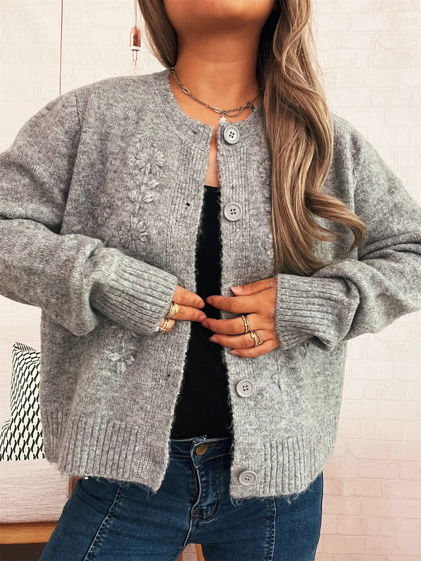 Gray cardigan with flower embroidery, round button front, ribbed cuffs and hem.