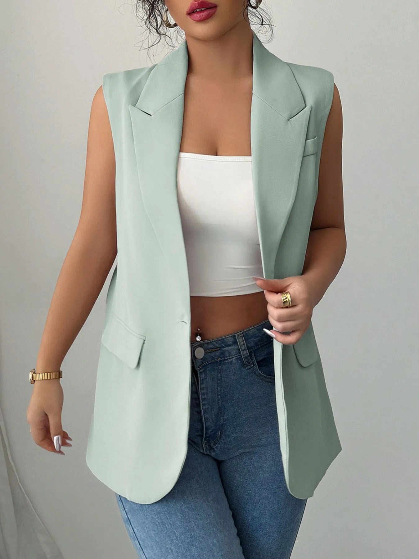Sage sleeveless blazer with one button and notched lapels