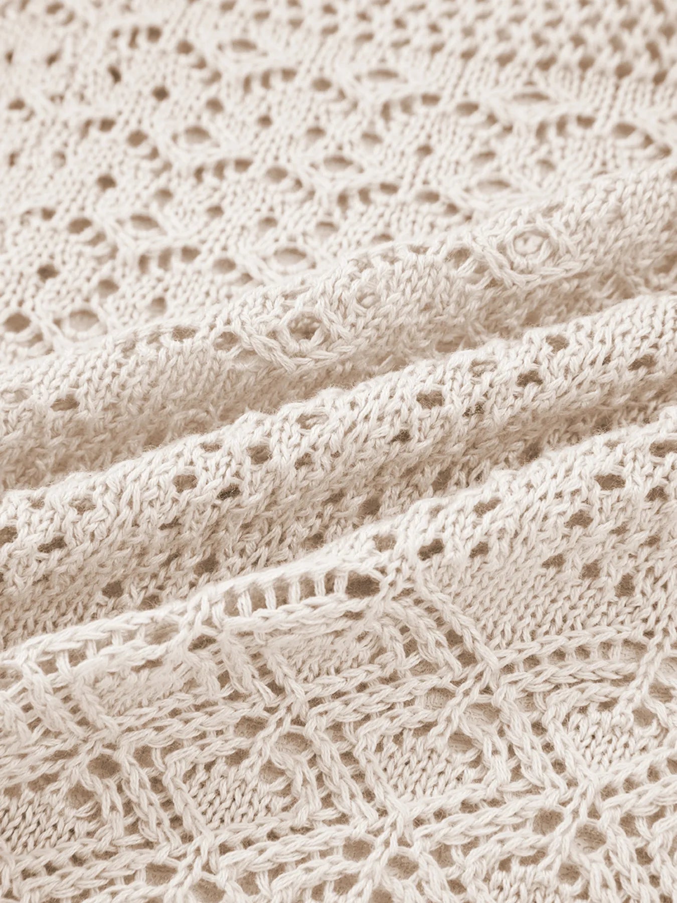 Beige openwork knit fabric with detailed hollow crochet stitch pattern