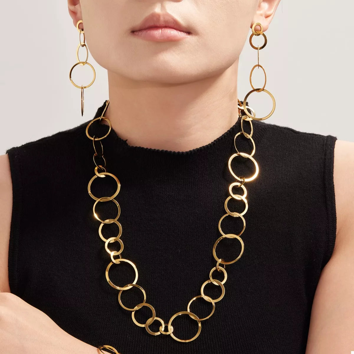Gold-plated chain link statement necklace with long oval-link strand at collar
