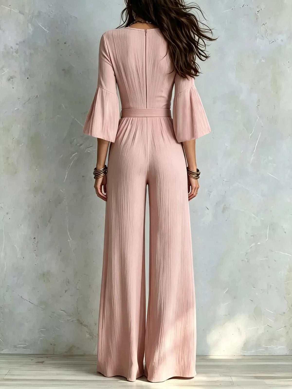 Pink wide-leg jumpsuit with pleated back waist and tie belt detail