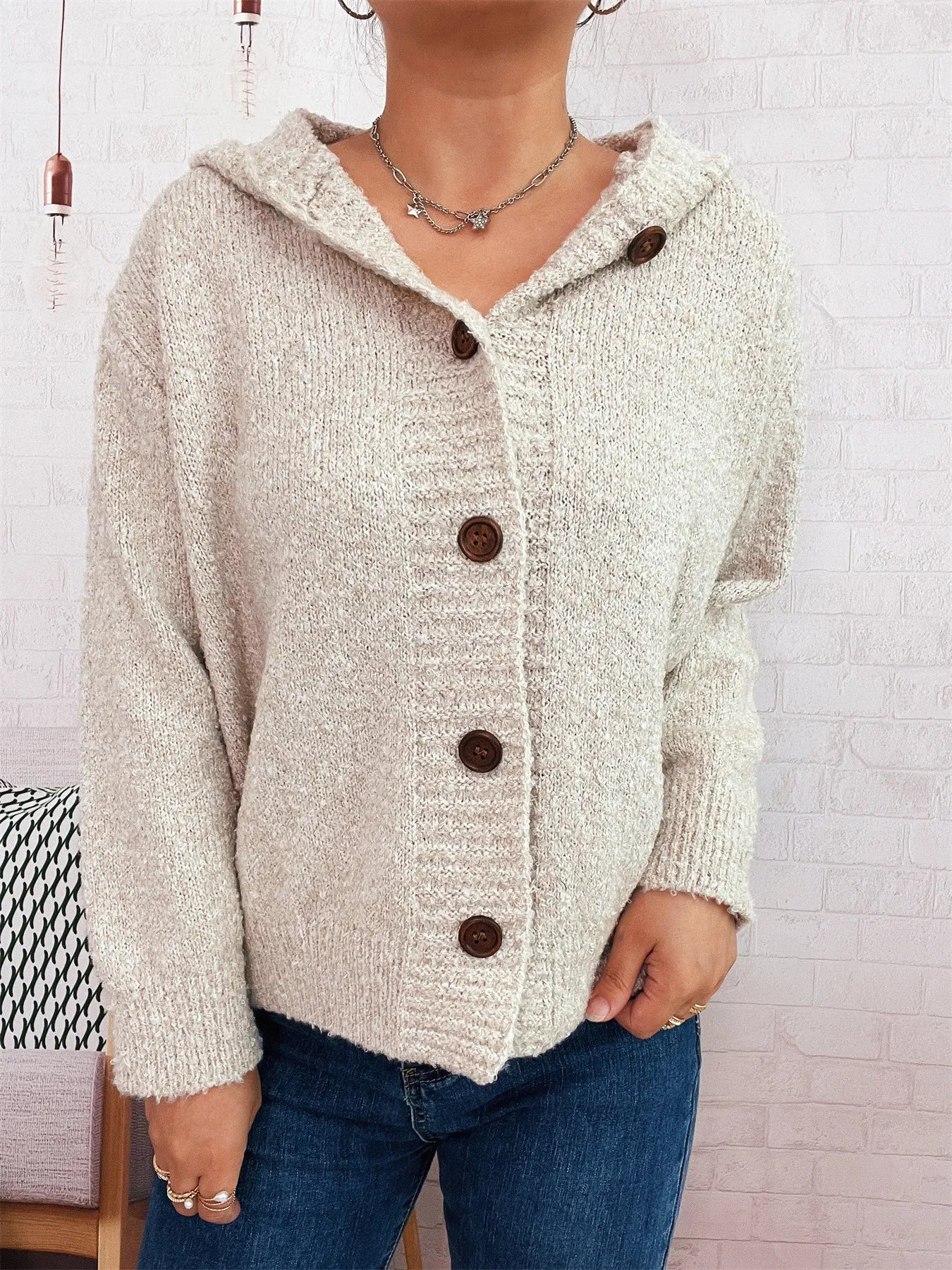 Cozy hooded cardigan, cream textured knit with long sleeves and buttons.