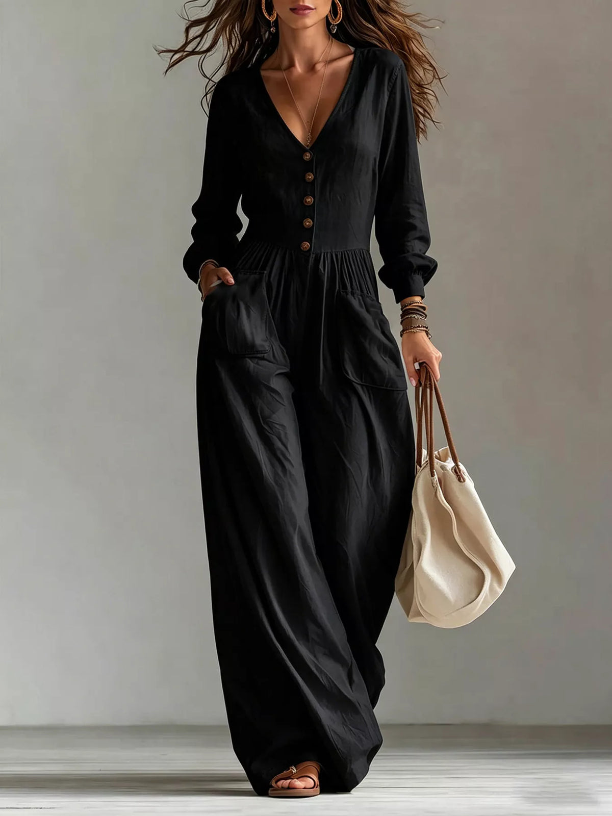 Black V-neck long-sleeve button-front jumpsuit with wide legs and side pockets