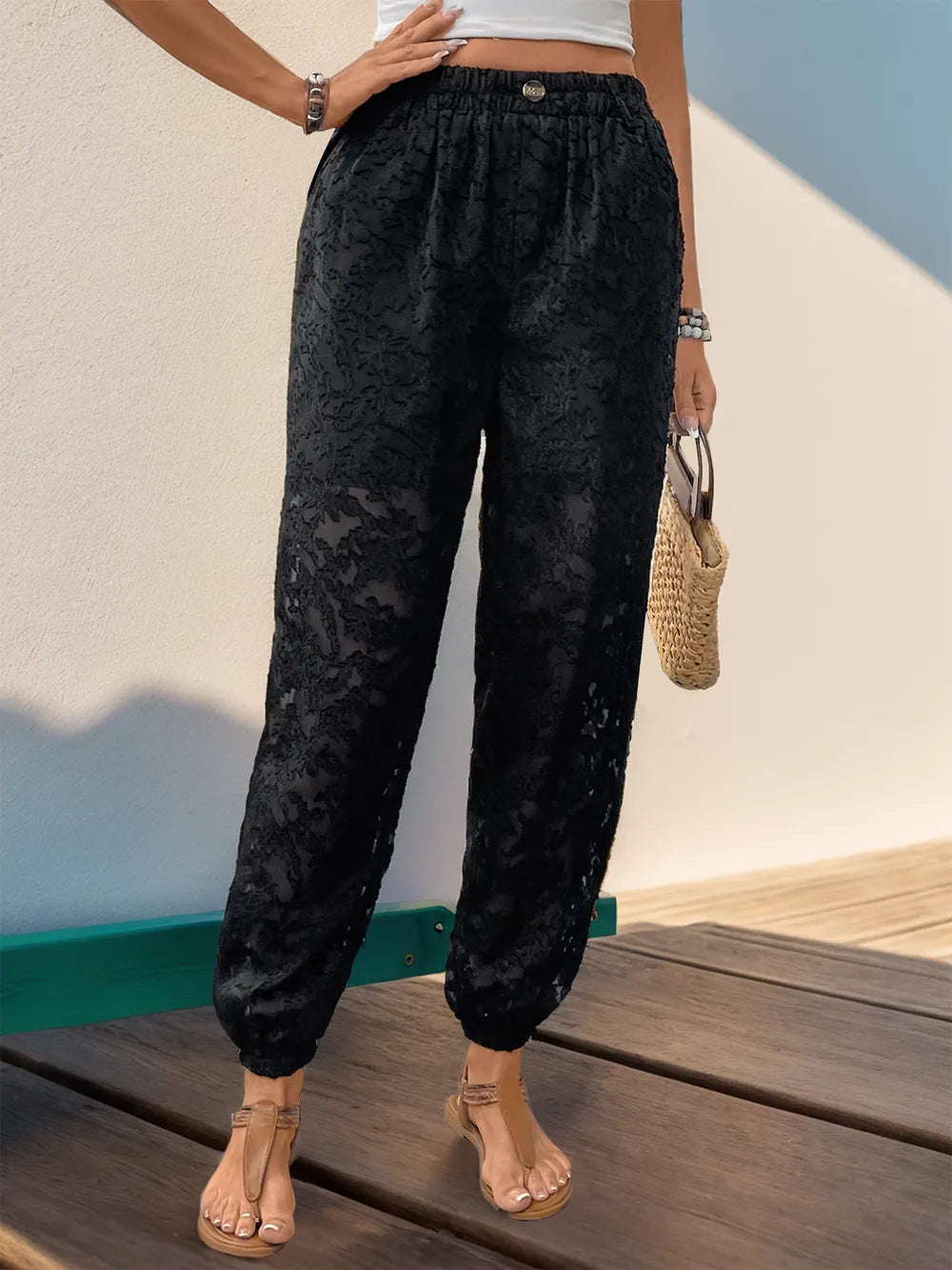 Black lace elastic-waist pants with front pockets and ankle cuffed hems
