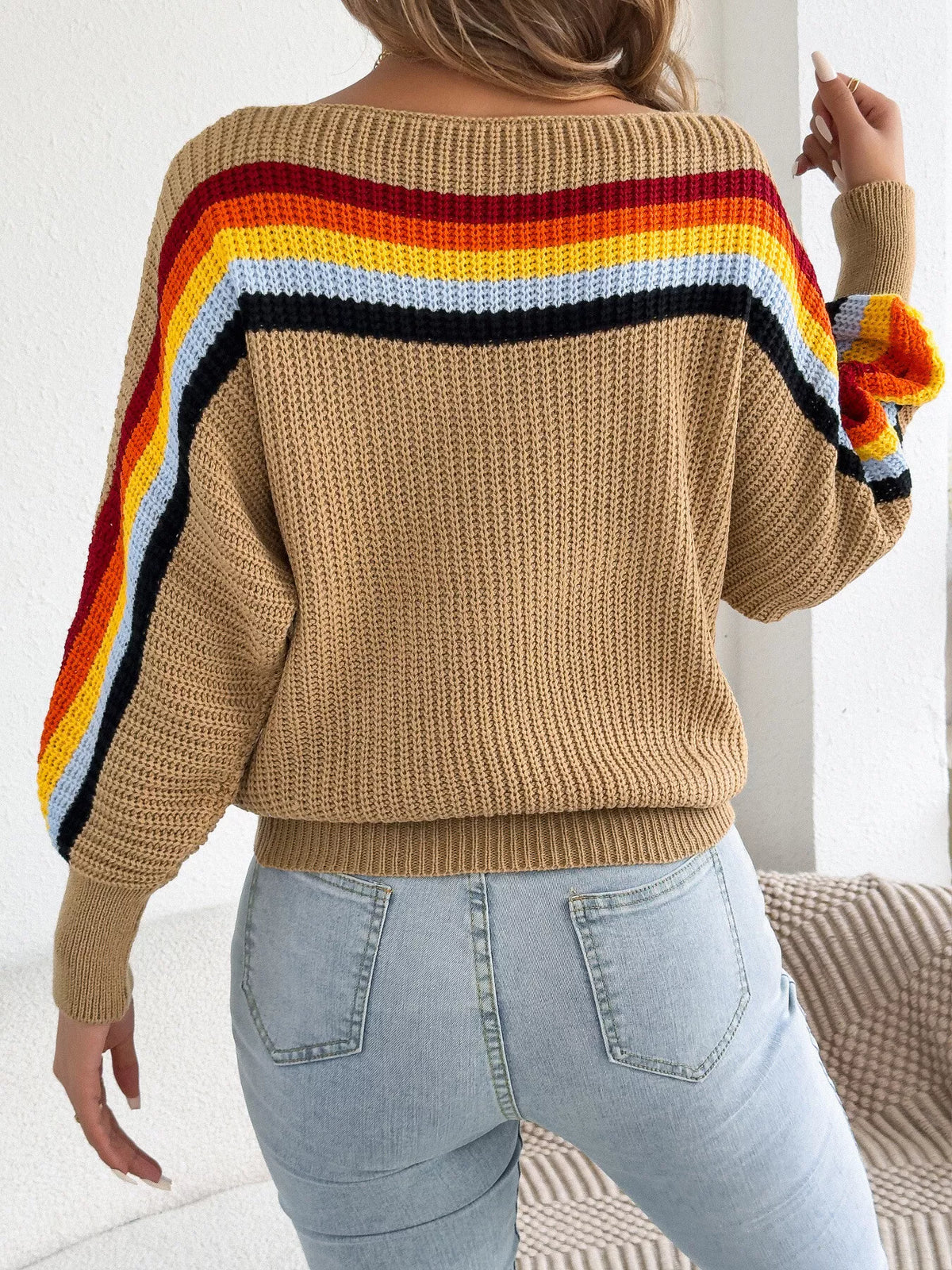 Beige back view ribbed knit boat-neck sweater with rainbow stripe yoke and hem
