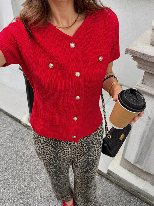 Red short-sleeve cardigan with V-neck, chest pockets, and gold button front