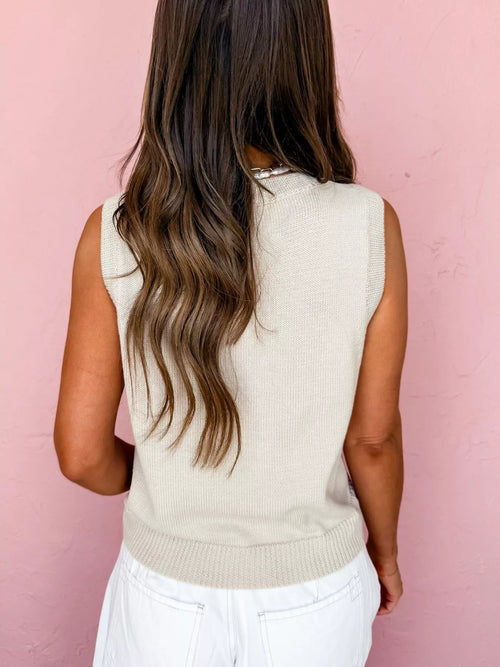 Beige knit sweater vest back view, sleeveless with ribbed neckline