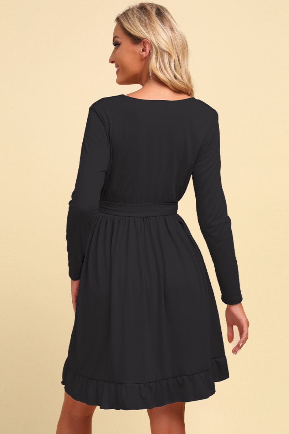 Long sleeve tie-waist ruffle hem dress, black back view with gathered ruffle hem