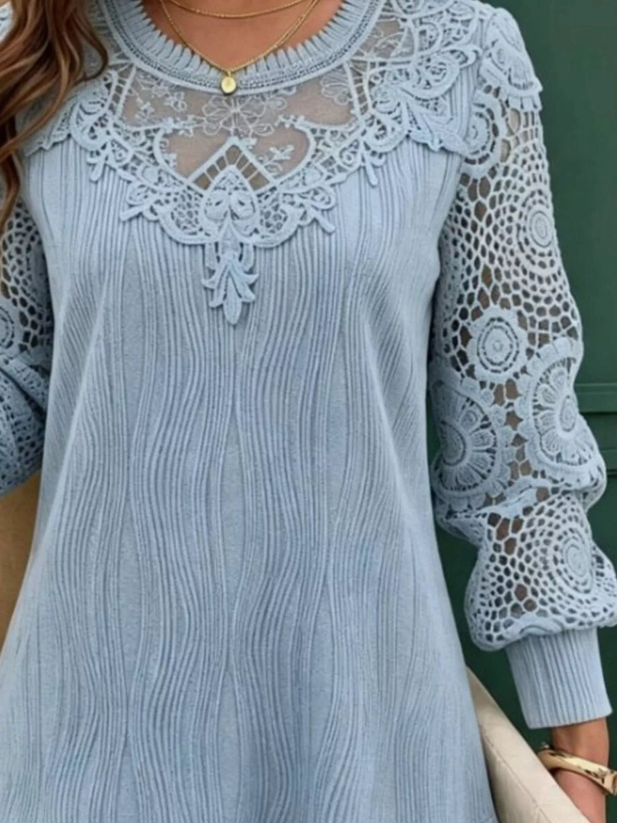 Light blue long-sleeve blouse with lace shoulder overlay and vertical pleat-style front