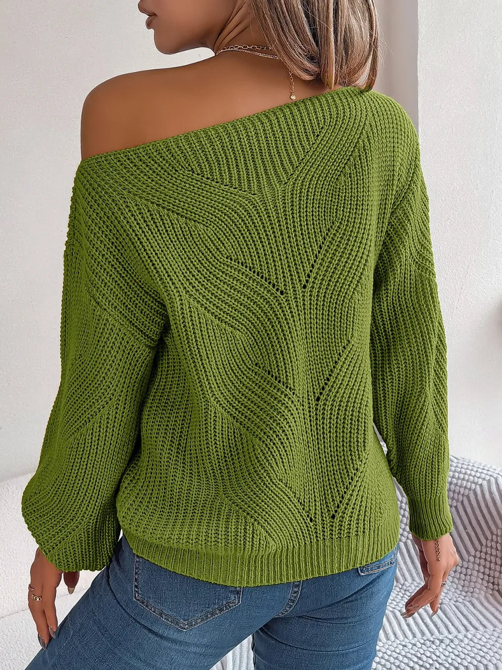 Moss green openwork long sleeve sweater with off-shoulder neckline and V-pattern knit on back.