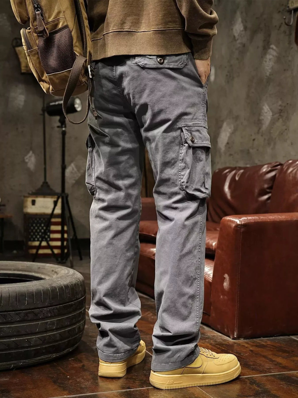 Mens multi-pocket drawstring cargo pants in dark gray with utility cargo pockets