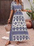 Cedar & Moore Floral Print Cutout Waist Maxi Dress by Trendsi in navy and white with waist cutout and slit