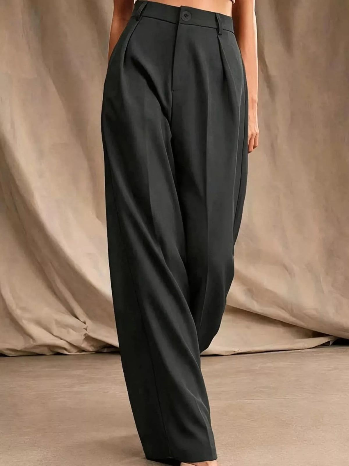 Black high-waisted pleated wide-leg pants with belt loops and front button closure