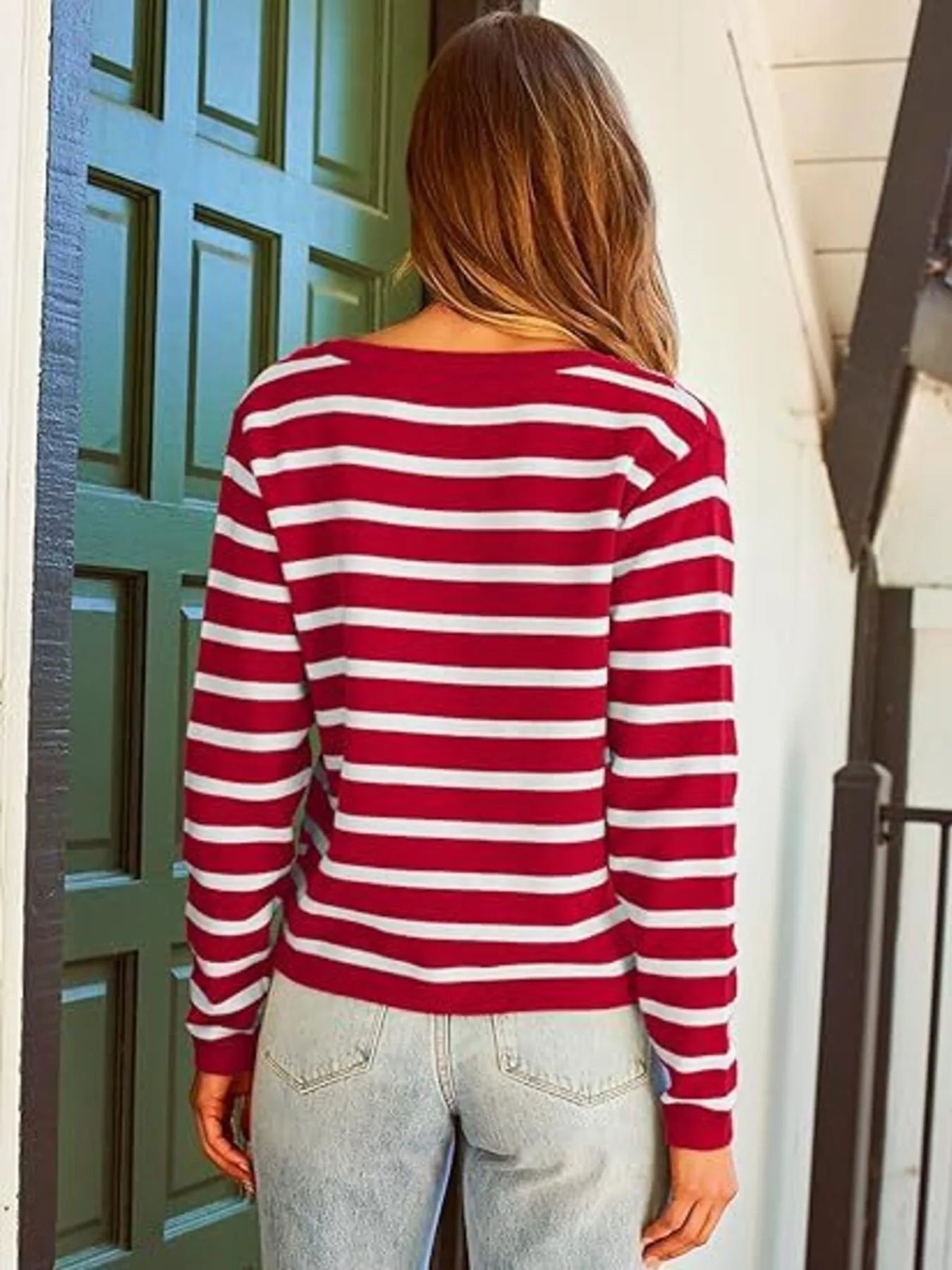Red-and-white striped button-up cardigan with long sleeves and gold button placket