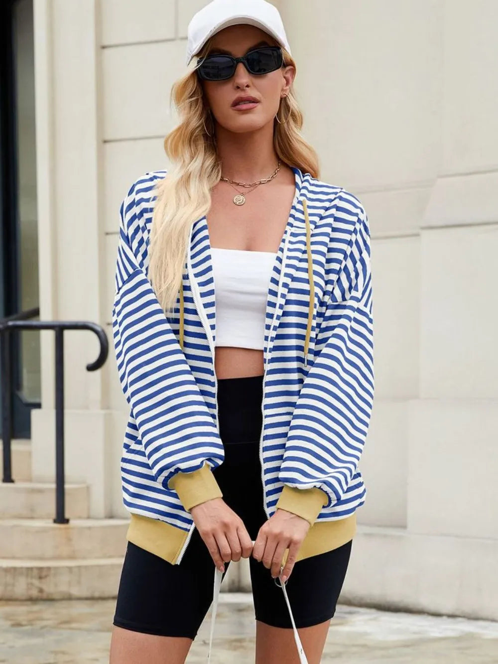 Blue-and-white striped zip-up hoodie with hood, front zipper, long sleeves, yellow trim.