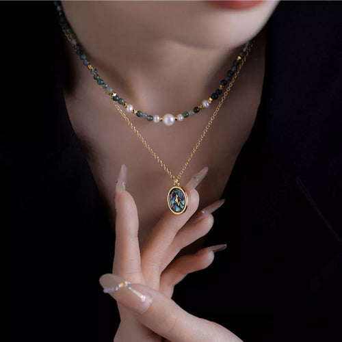 Gold-plated oval pendant with blue inlay, paired with multicolor bead and pearl choker