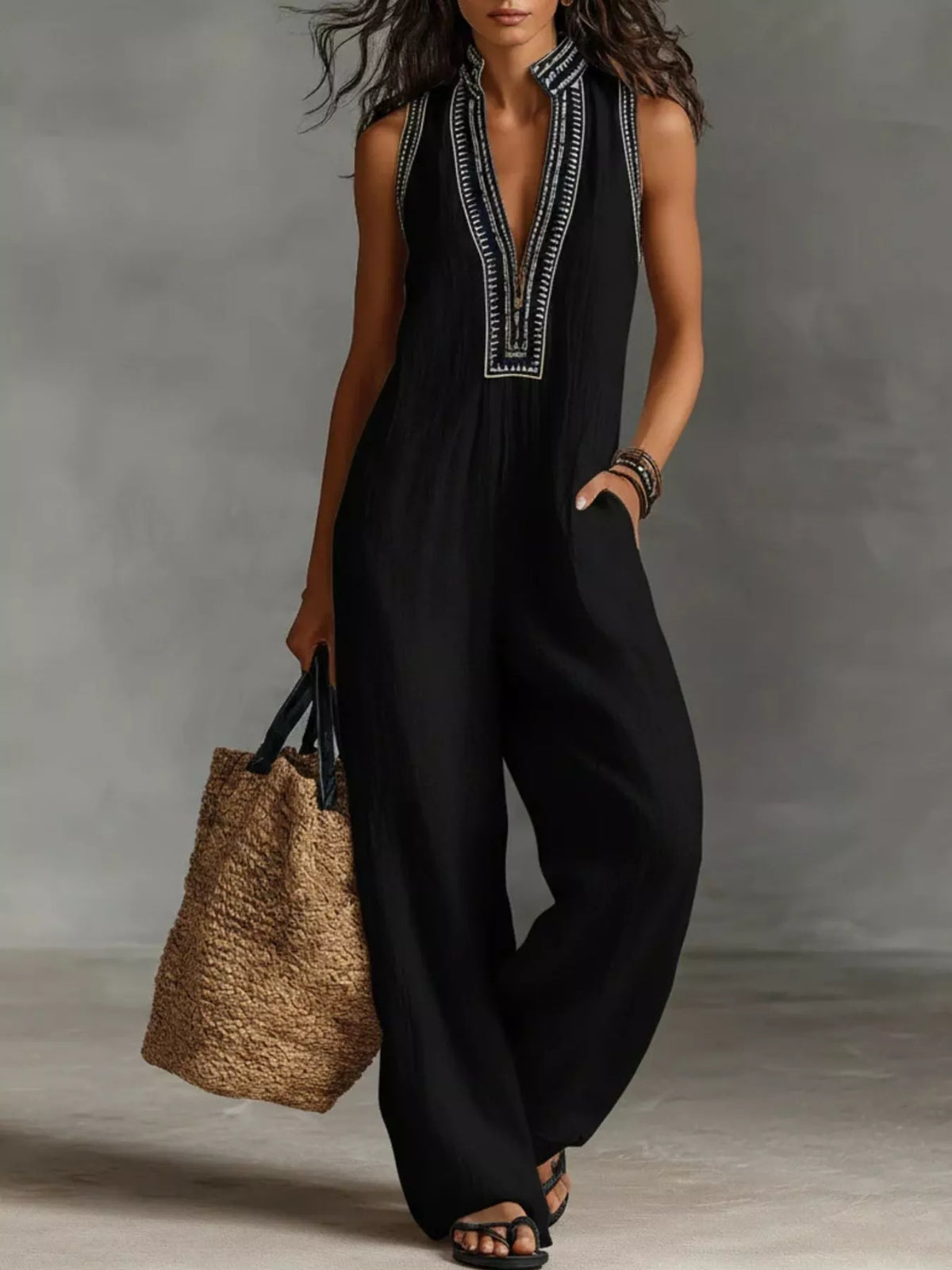 Black sleeveless wide-leg jumpsuit with V-neck embroidery trim and side pockets